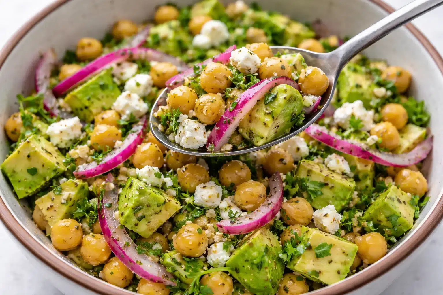 Colorful Chickpea Feta Avocado Salad with fresh ingredients in a bowl