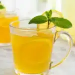 Homemade Starbucks Medicine Ball Tea served in a cozy cup with fresh lemon slices.
